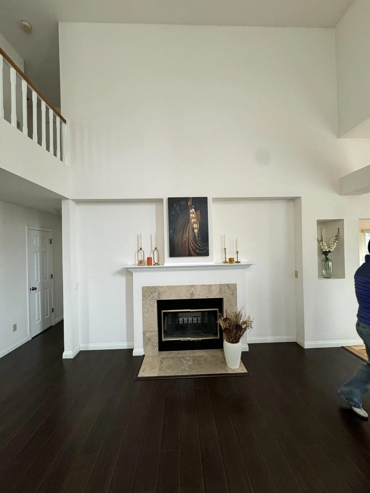 Fireplace wall before custom built-ins were added — bare wall dark hardwood floors Reno NV