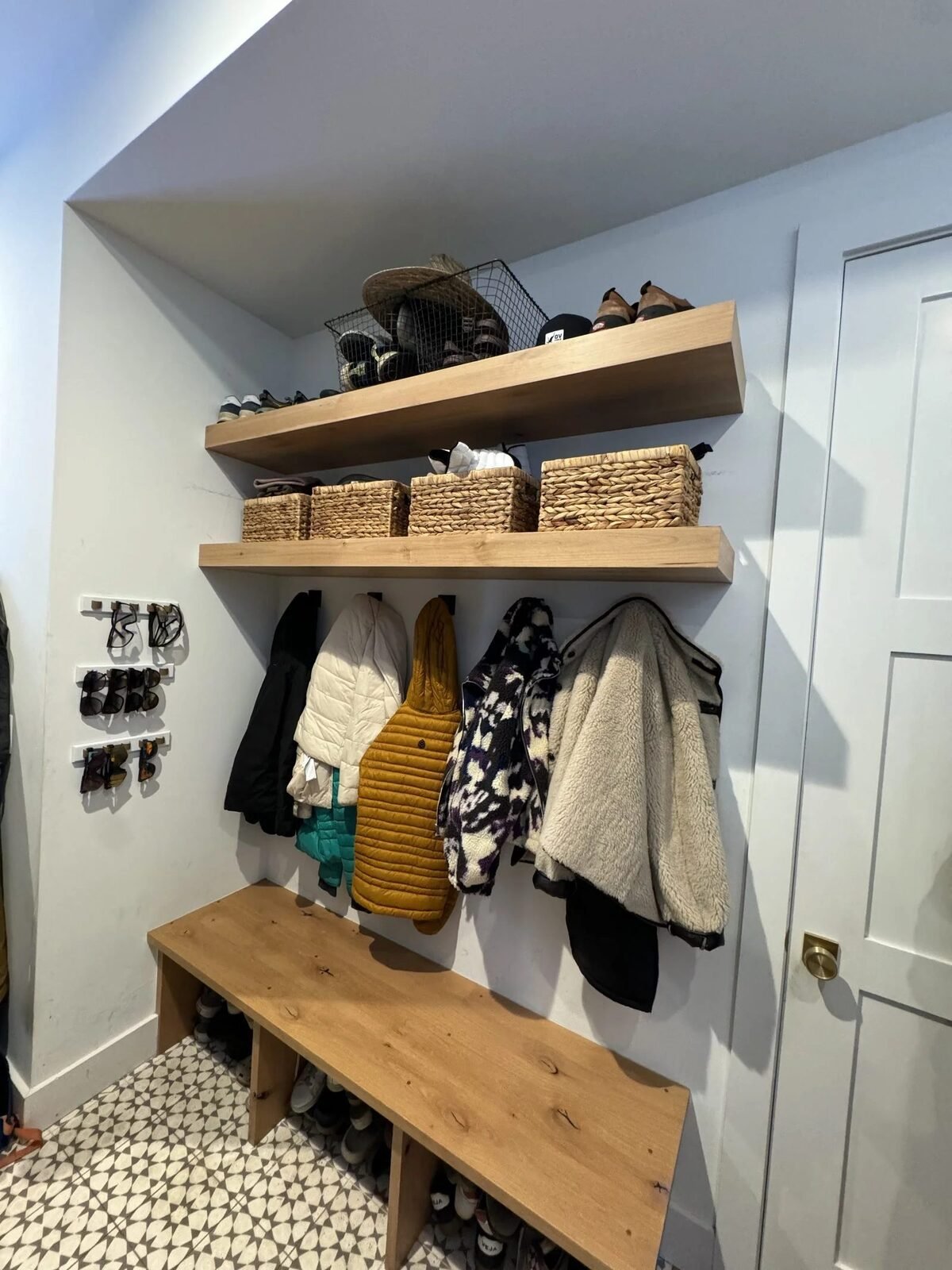 Custom mudroom with floating shelves bench and patterned tile Reno NV