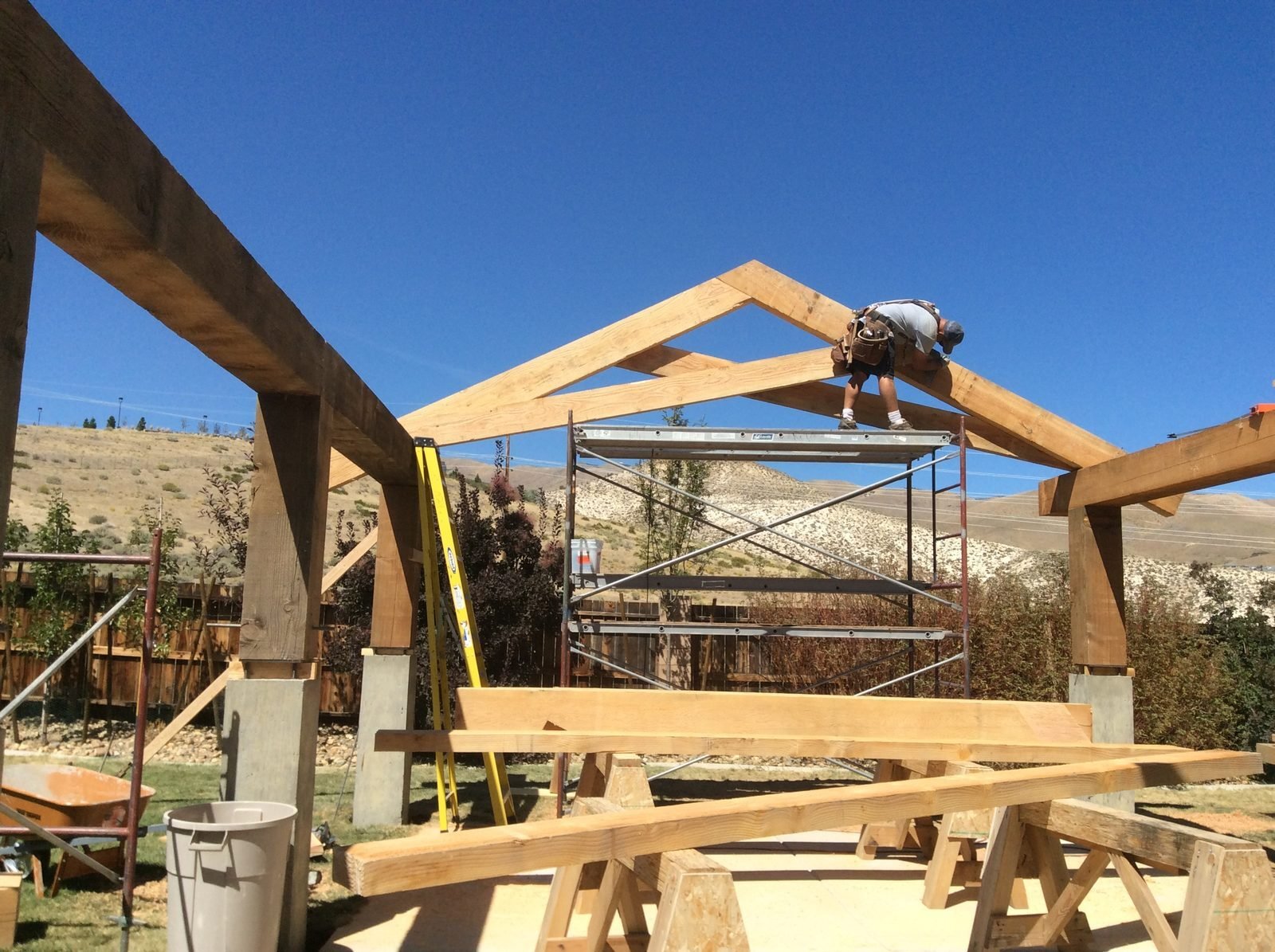 Heavy timber patio cover being framed with ridge beam and arched posts Reno NV